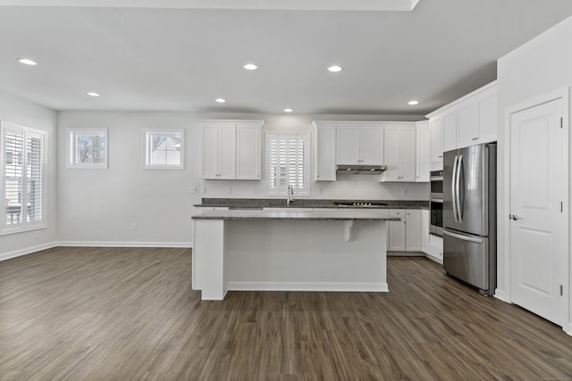 kitchen featuring a kitchen island, appliances with stainless steel finishes, and white cabinets