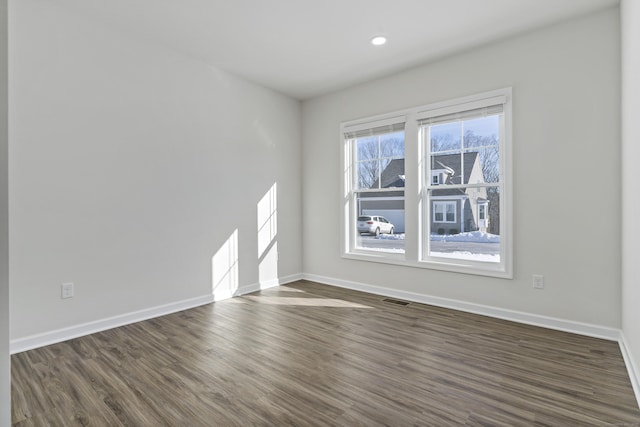 unfurnished room with dark wood-type flooring