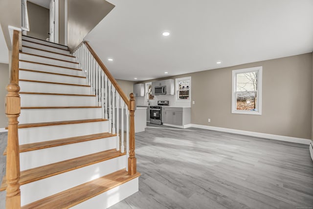 stairway with hardwood / wood-style flooring