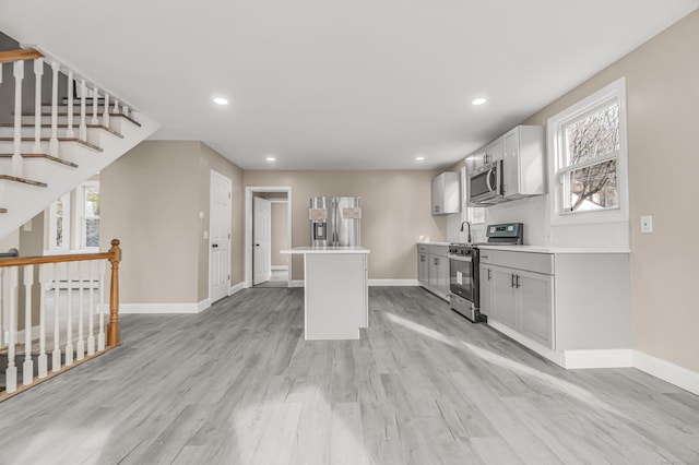 kitchen with plenty of natural light, stainless steel appliances, and light hardwood / wood-style floors