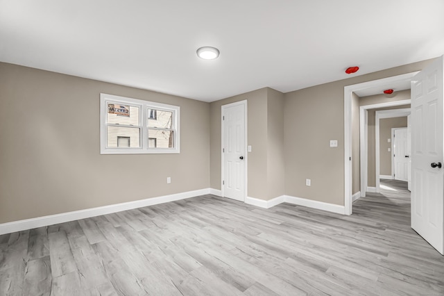 unfurnished room with light wood-type flooring