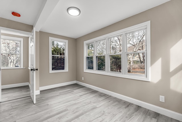 spare room featuring light hardwood / wood-style floors