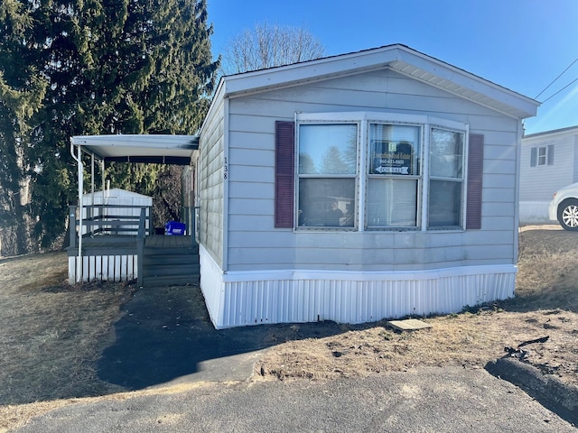 view of side of home featuring driveway