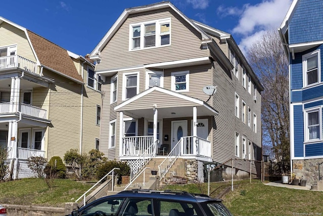 view of front facade with a front yard and a porch