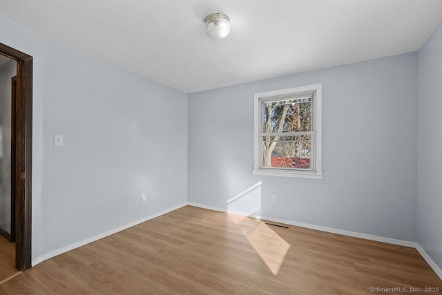 unfurnished room featuring light hardwood / wood-style floors