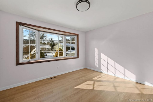 spare room featuring light wood-type flooring