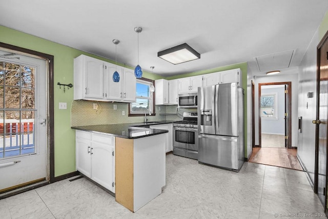 kitchen with white cabinetry, appliances with stainless steel finishes, sink, and decorative backsplash