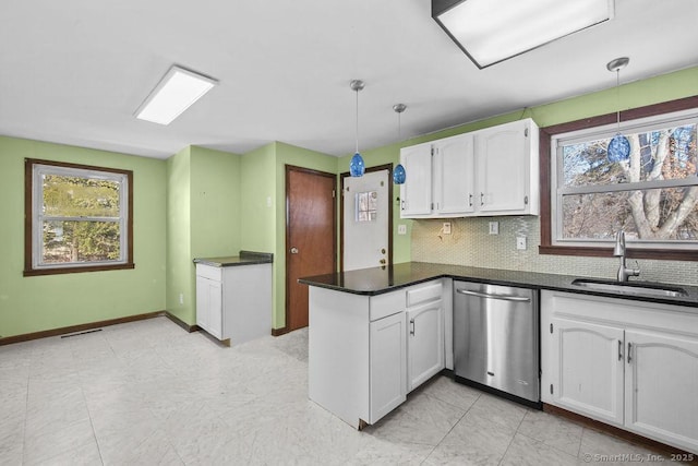 kitchen with white cabinetry, dishwasher, sink, and hanging light fixtures