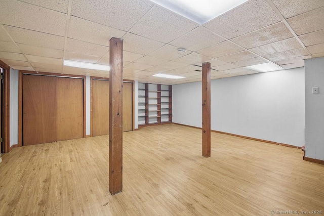 basement with wood-type flooring and a drop ceiling