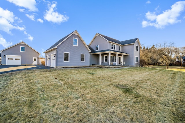 rear view of property with a porch, a garage, and a lawn