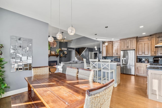 dining room featuring light hardwood / wood-style flooring and ceiling fan