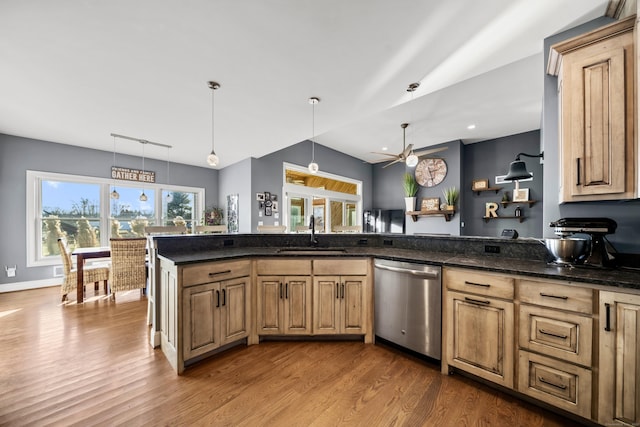 kitchen featuring hanging light fixtures, dishwasher, wood-type flooring, and sink