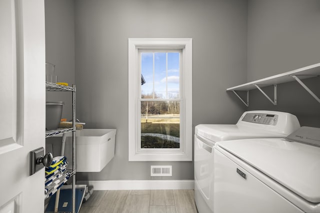 clothes washing area featuring washer and dryer