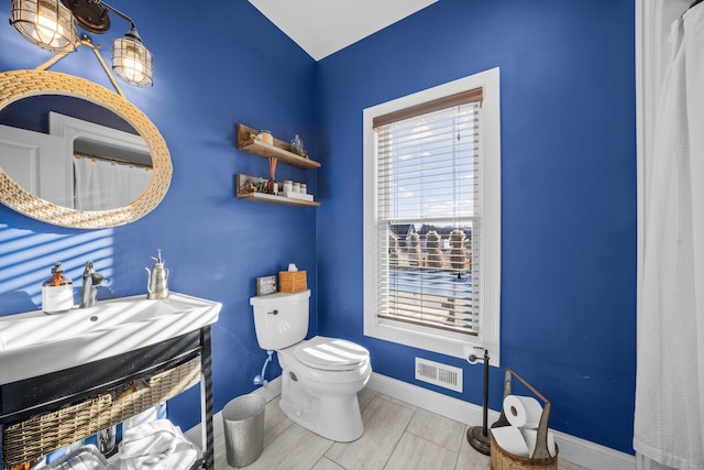 bathroom featuring tile patterned flooring, sink, and toilet