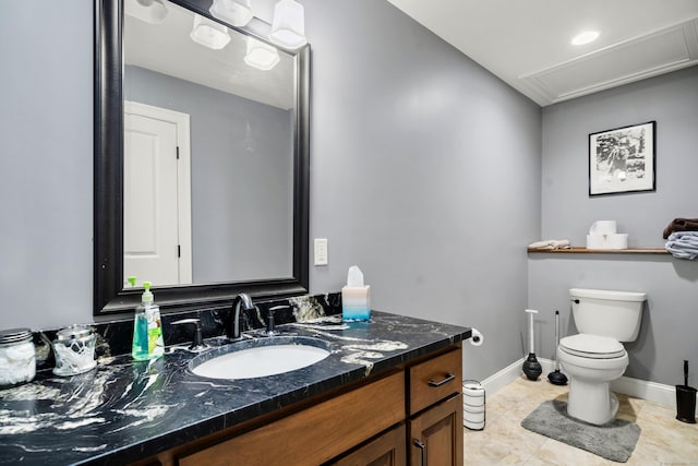 bathroom with vanity, tile patterned flooring, and toilet