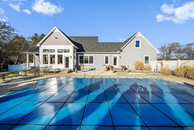 back of house with a covered pool and a patio area