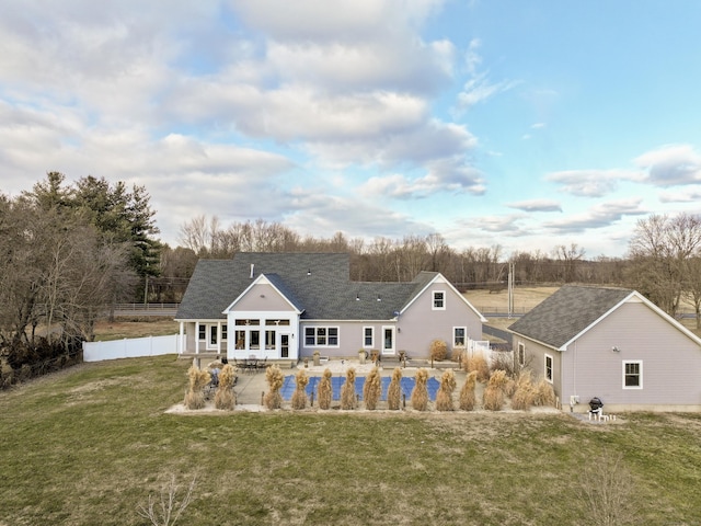 back of house with a pool, a yard, and a patio area