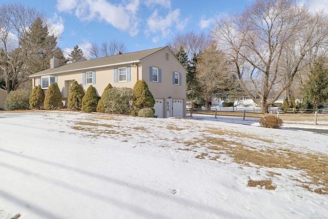 view of snowy exterior with a garage