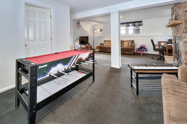 rec room with carpet flooring and a stone fireplace