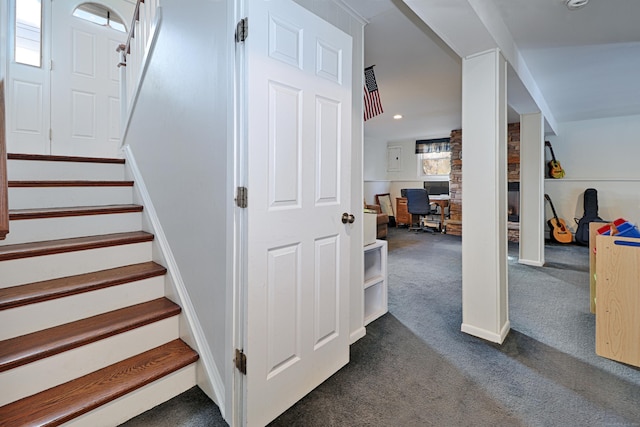 stairway featuring carpet flooring