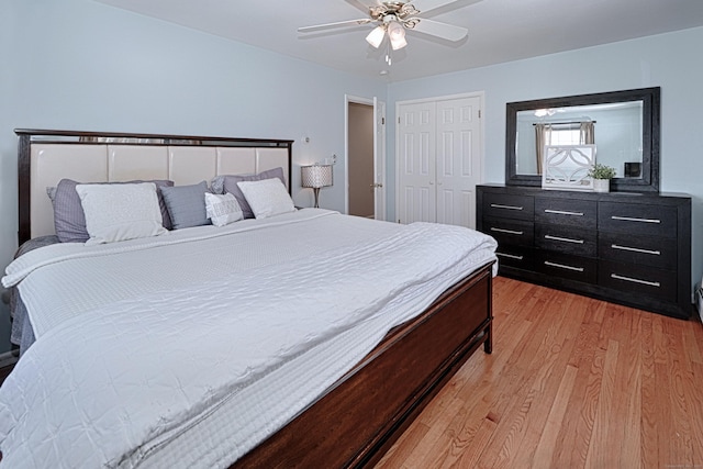 bedroom with ceiling fan, a closet, and light wood-type flooring