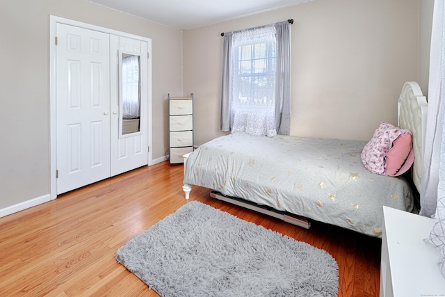 bedroom featuring hardwood / wood-style floors and a closet