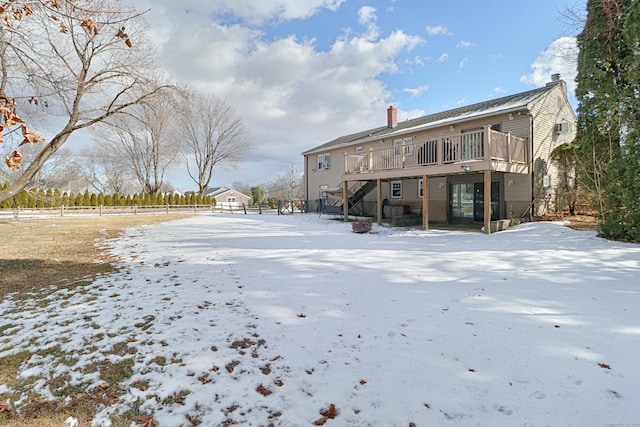 snow covered property featuring a wooden deck