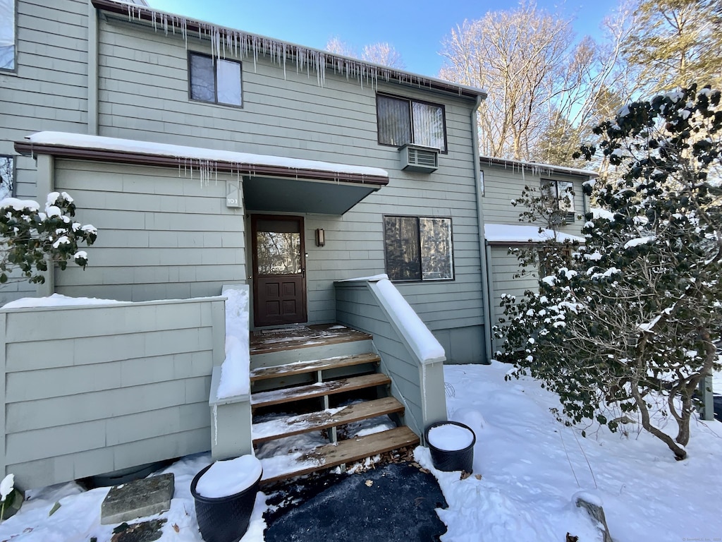 view of snow covered property entrance