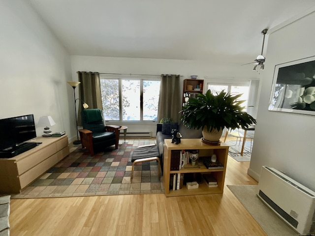 living room featuring ceiling fan, radiator heating unit, hardwood / wood-style floors, and a baseboard heating unit