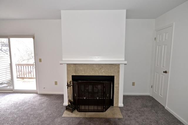 room details with a tile fireplace and carpet