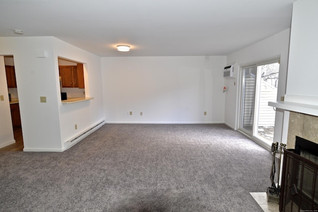 unfurnished living room featuring carpet floors, a wall unit AC, a fireplace, and baseboard heating