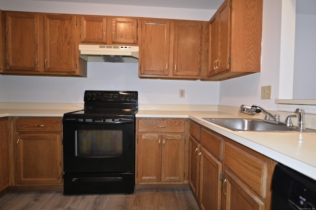 kitchen with sink, dark wood-type flooring, and black appliances