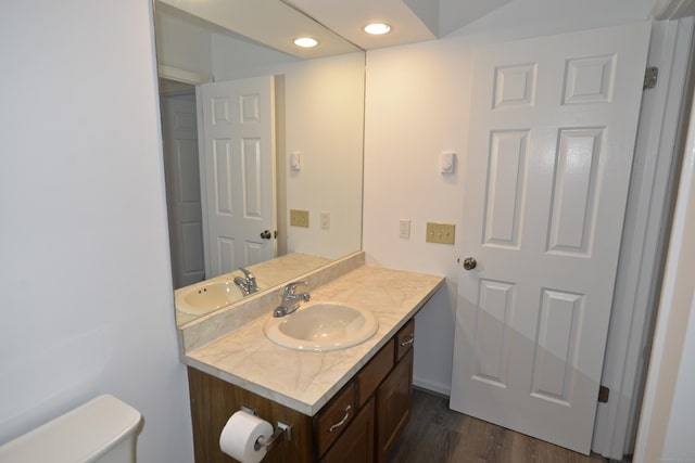 bathroom with vanity, hardwood / wood-style floors, and toilet