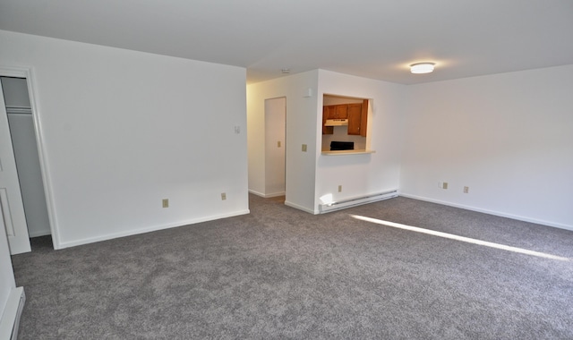 unfurnished living room featuring dark carpet and a baseboard heating unit