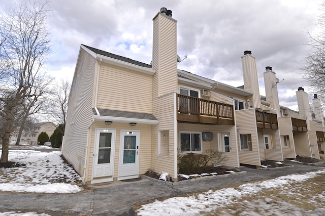 snow covered property featuring a balcony