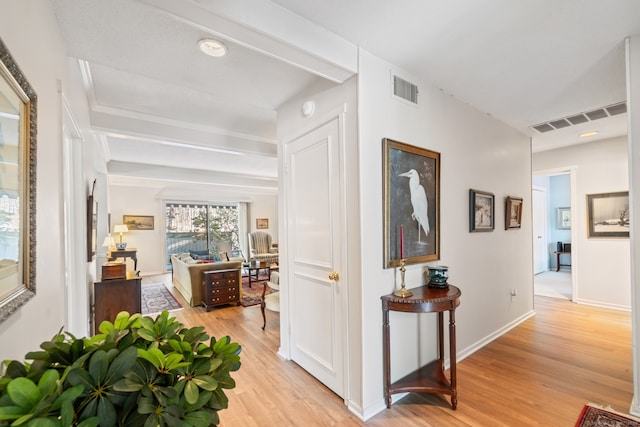 hallway featuring beam ceiling and light wood-type flooring