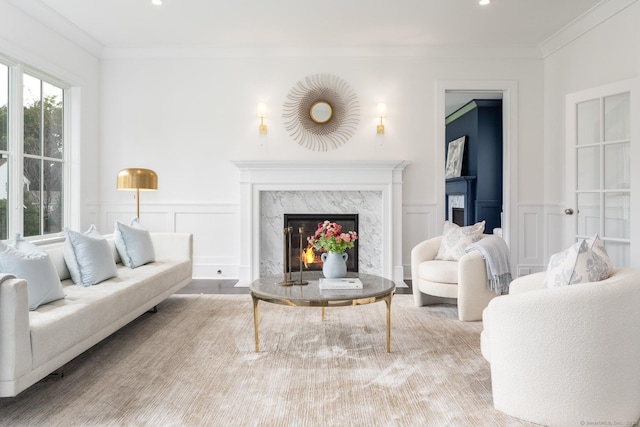 living room featuring ornamental molding and a premium fireplace