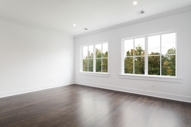 unfurnished room featuring crown molding, plenty of natural light, and dark hardwood / wood-style flooring