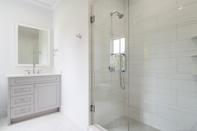 bathroom with vanity, a shower with shower door, and ornamental molding