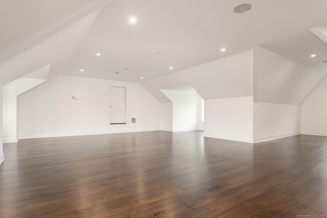 additional living space featuring lofted ceiling and dark hardwood / wood-style flooring