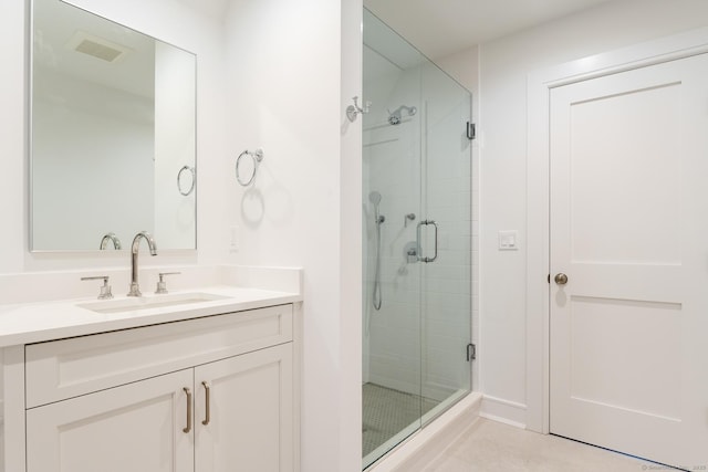 bathroom featuring vanity and a shower with shower door