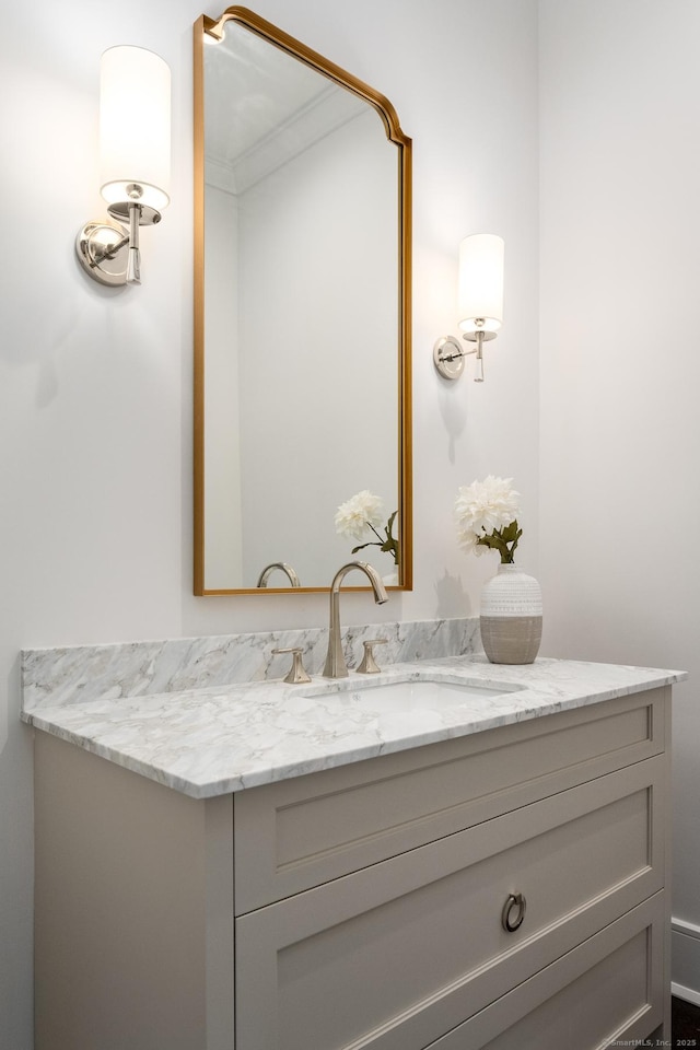 bathroom with vanity and ornamental molding