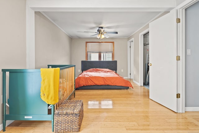 bedroom with crown molding, ceiling fan, and hardwood / wood-style flooring