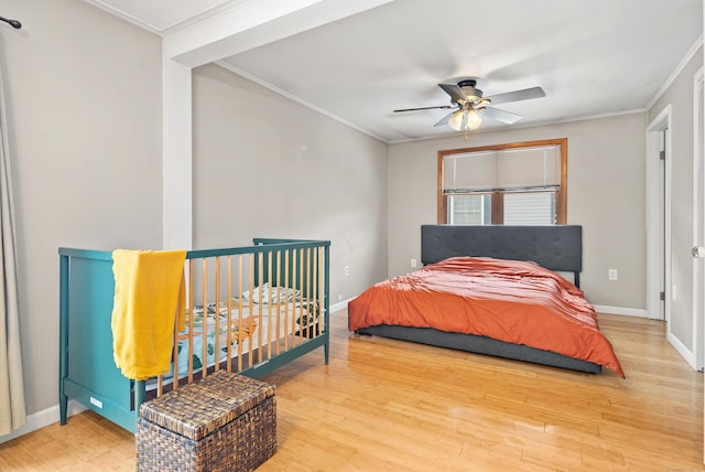 bedroom with ornamental molding, hardwood / wood-style floors, and ceiling fan