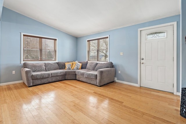 living room featuring vaulted ceiling and light wood-type flooring