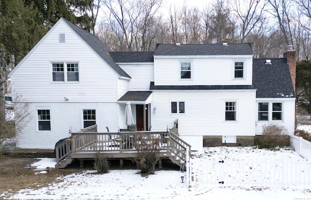 snow covered house featuring a deck