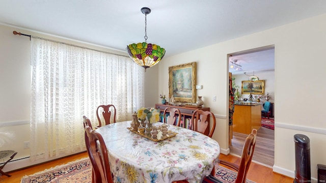 dining area featuring hardwood / wood-style flooring and a baseboard heating unit