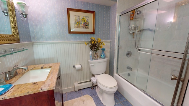 full bathroom with a baseboard radiator, shower / bath combination with glass door, vanity, toilet, and tile patterned floors