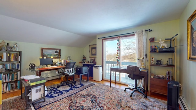 office with lofted ceiling, wood-type flooring, and a baseboard heating unit