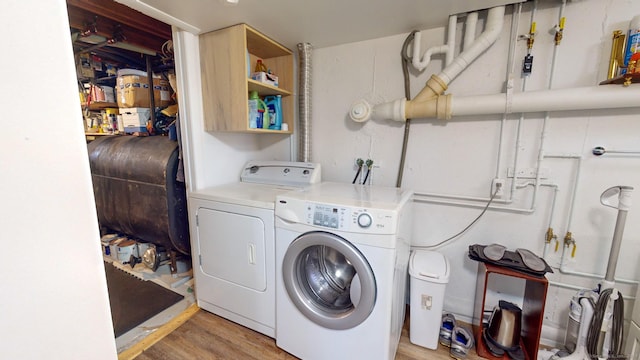 4 Alpine Dr, South Windsor, CT 06074 - clothes washing area featuring washer and dryer, laundry area, heating fuel, and light wood-style flooring